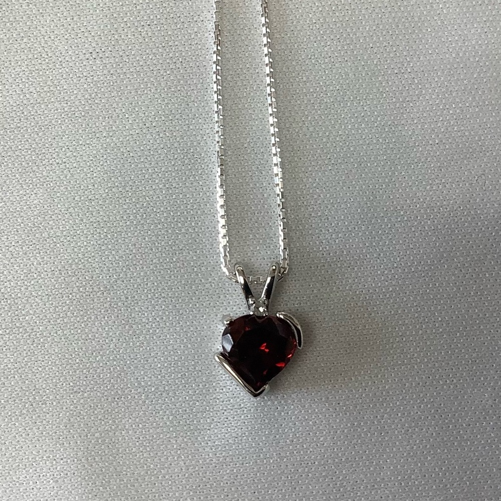 Garnet, heart shaped with diamond pendant  on a sterling silver 16” chain.